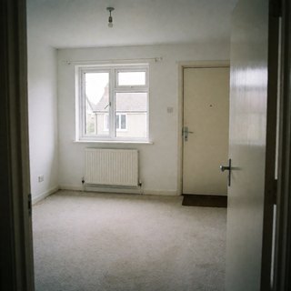 The empty living room the buyer photographed from the doorway
